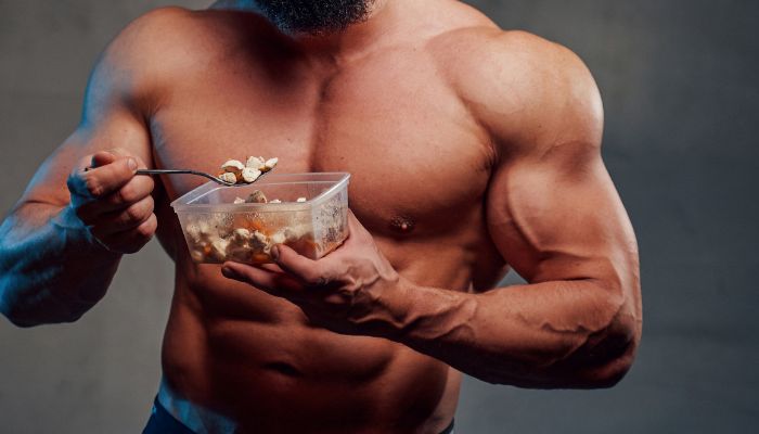 bodybuilder eating protein meal